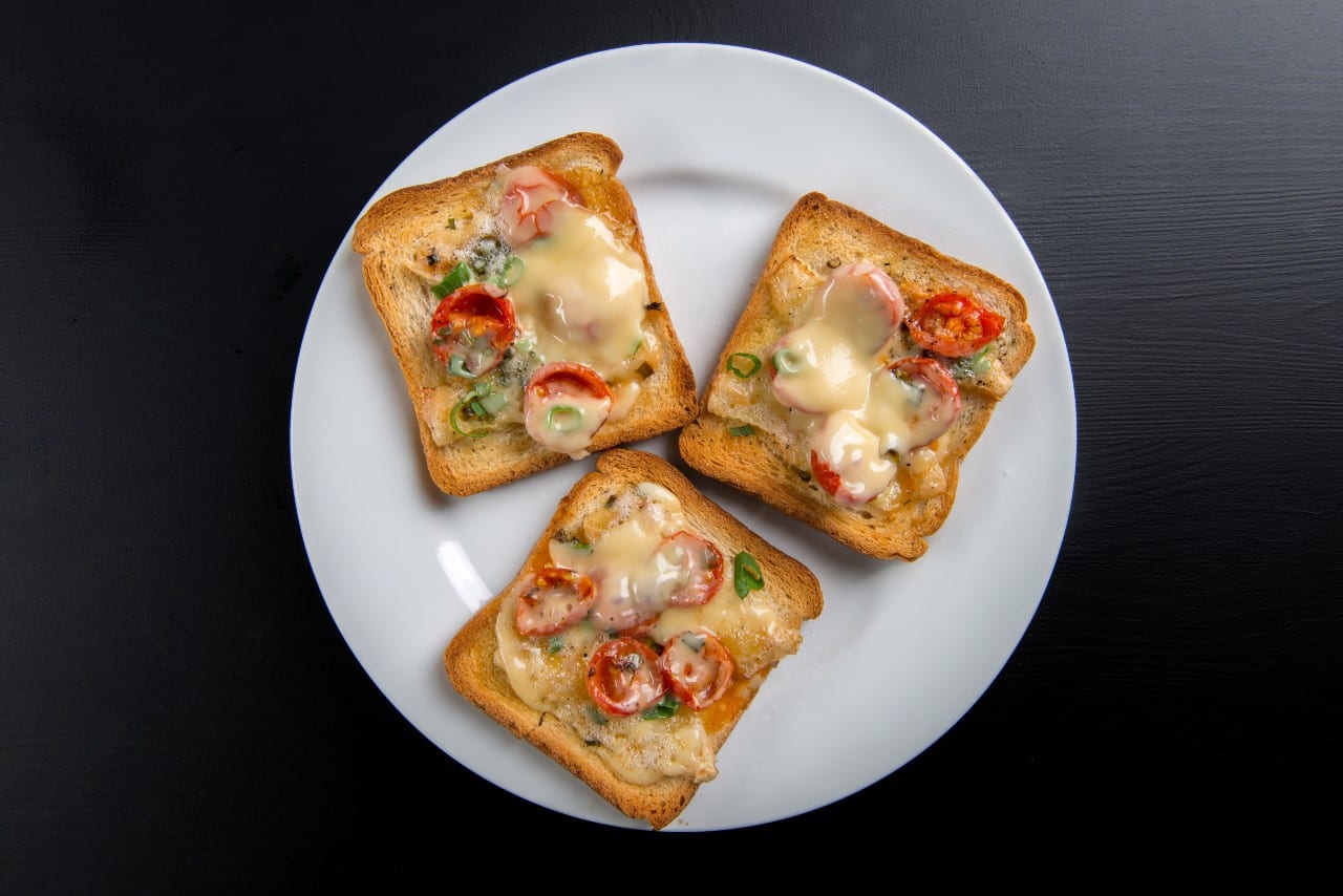 19 Must-Try Monsoon Recipes for Perfect Rainy Evenings 9 Chilli Cheese Toast in a plate black background