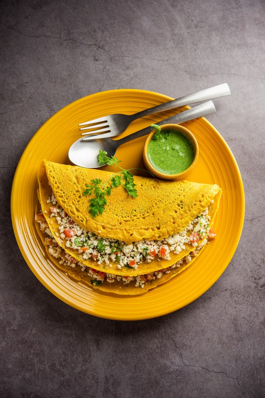 19 Must-Try Monsoon Recipes for Perfect Rainy Evenings 7 Moong Dal Chilla in a yellow plate