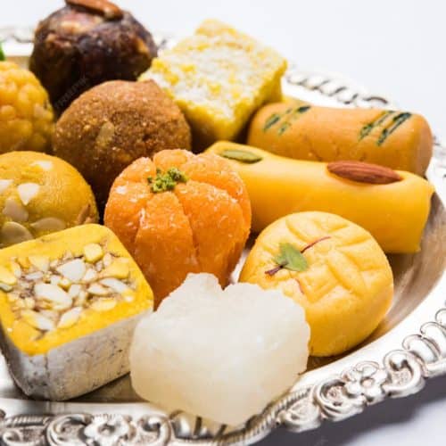 What Are the 20 Must-Try Indian Dessert Recipes? 34 Indian sweets on a silver platter