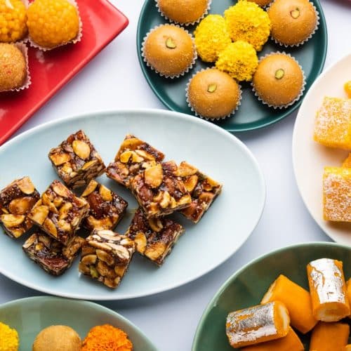 What Are the 20 Best Indian Sweets of All Time? 21 An assortment of colorful Indian sweets mithai arranged on several plates