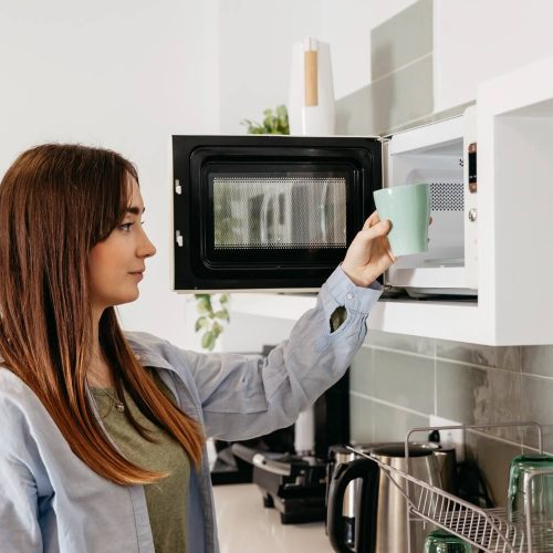 What Is Microwave Cooking, How It Works, and Recipes You Can Cook in a Microwave 21 A woman taking out her cup from a microwave