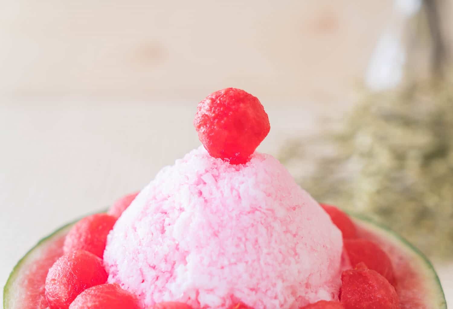 Which 25 Singapore Food Dishes Should You Try? 11 A close up of a watermelon bingsu dessert featuring a mound of pink shaved ice topped with a watermelon ball