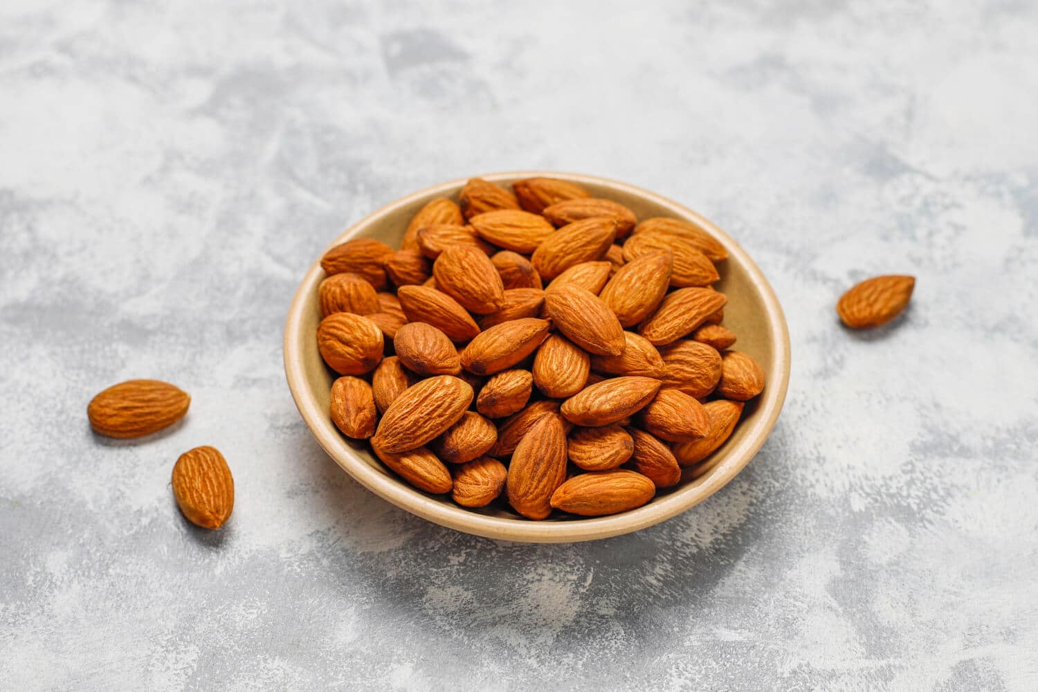 Which Heart Healthy Foods Should You Eat Daily? 5 Almonds freshly placed on a marbel bowl
