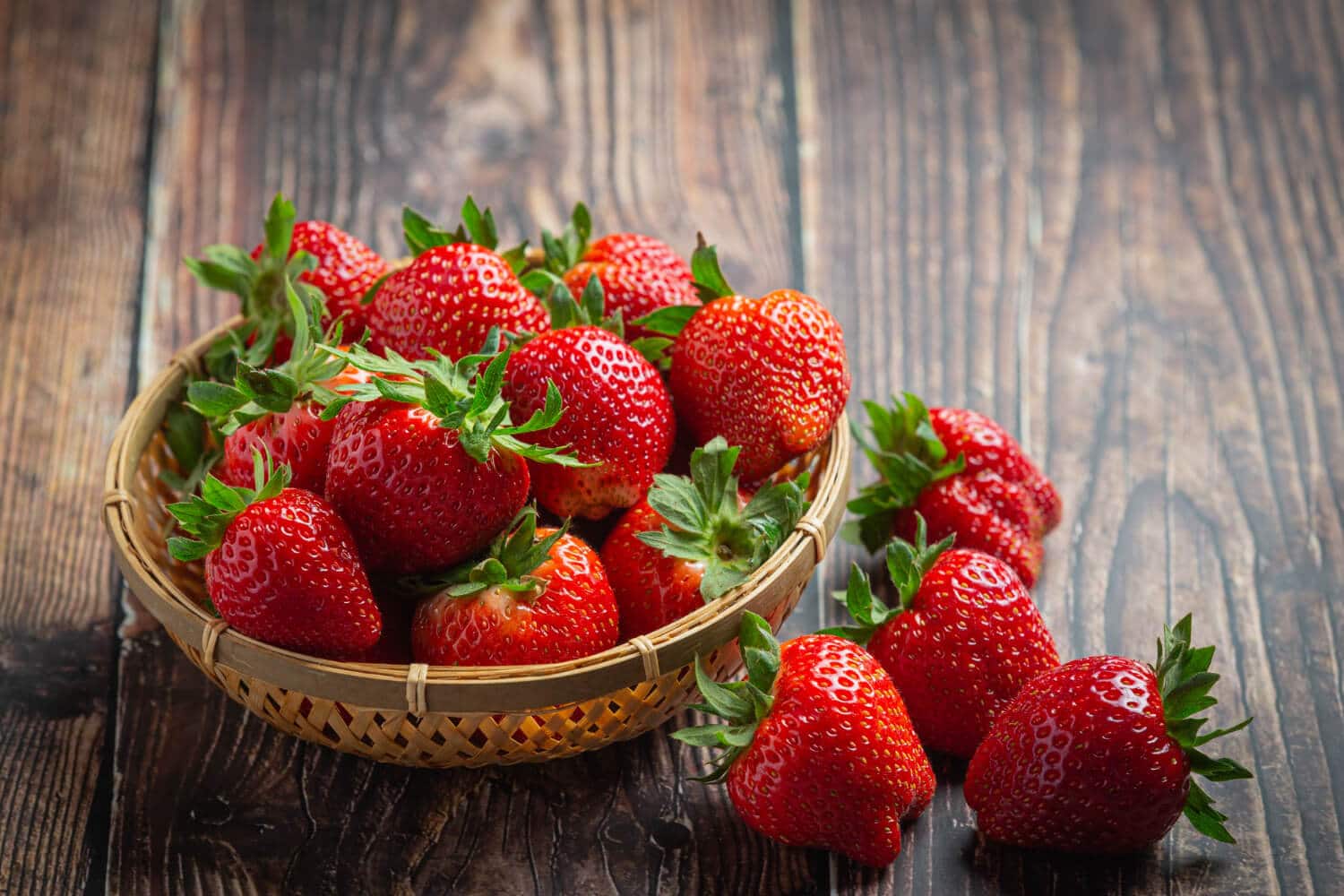 Which Heart Healthy Foods Should You Eat Daily? 4 Fresh strawberries placed on a wooden table