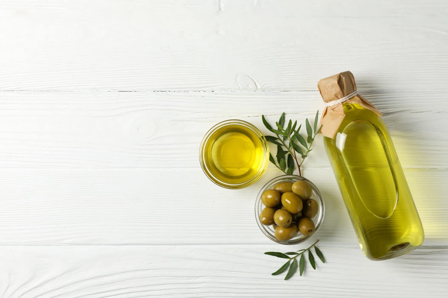 Which Heart Healthy Foods Should You Eat Daily? 8 Olive oil over white table with raw olives