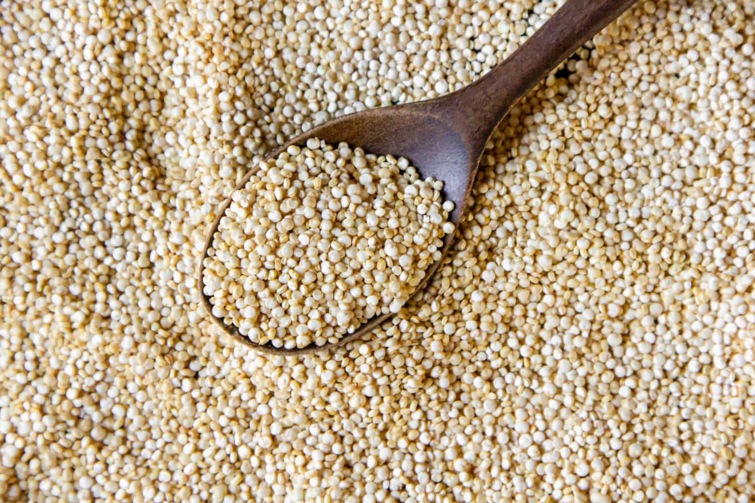 Which Heart Healthy Foods Should You Eat Daily? 20 Quinoa grains with a wooden spoon