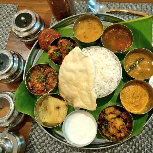 Where Can You Find the Best South Indian Food? 28 Colourful South Indian thali on banana leafTraditional South Indian meal served on banana leaf with rice curries chutneys and