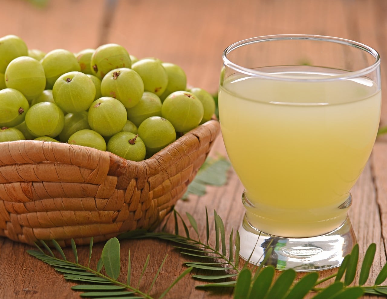 A bowl of Amla and a glass of Amla juice