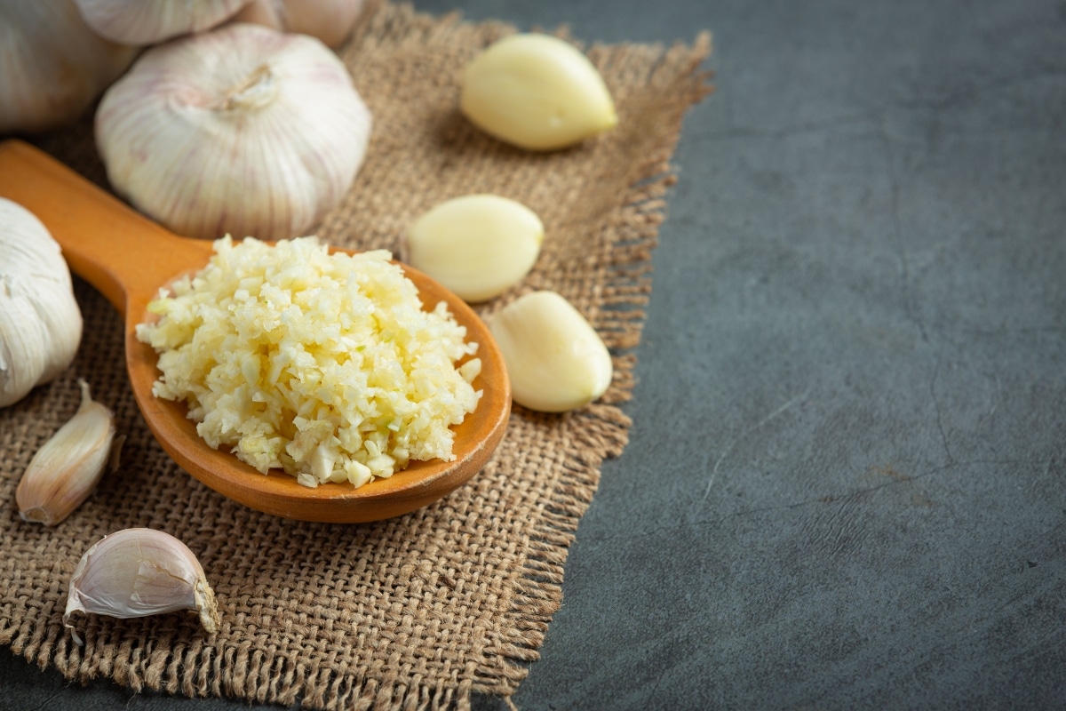 Minced garlic on a wooden spoon