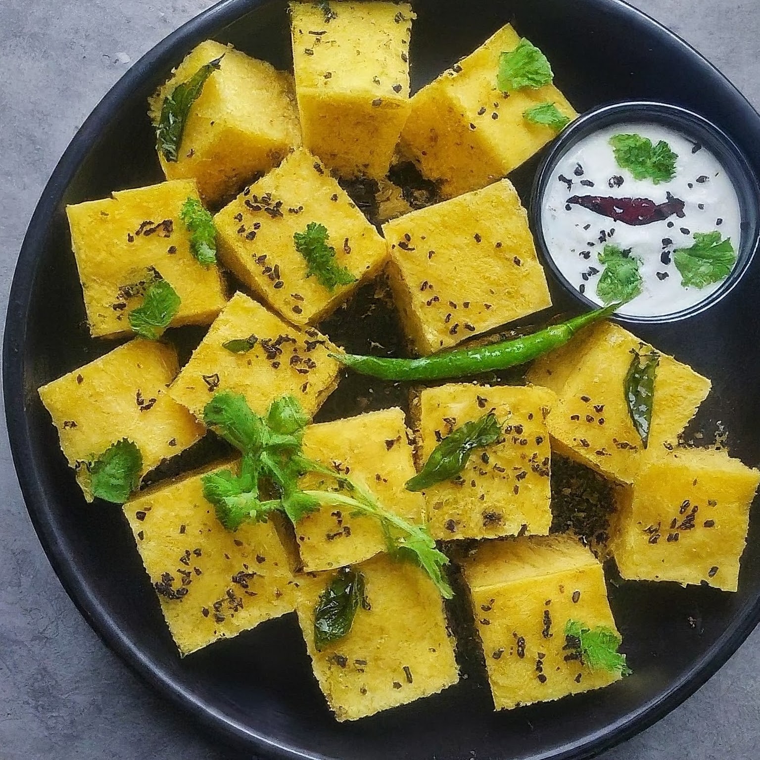 Dhokla, a steamed savoury cake made with a fermented batter of lentils and rice.
