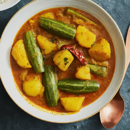 What Is Odisha’s Famous Food? 20 Must-Try Dishes 17 Aloo Potala Rasa Odia curry with potatoes and pointed gourd in light spiced gravy