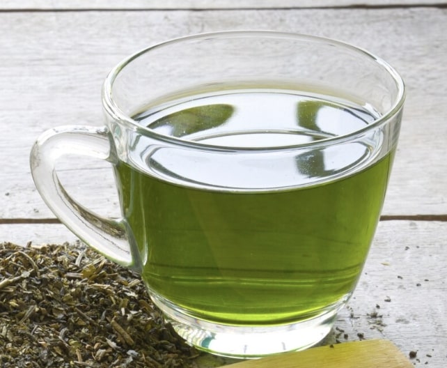 green tea and tea leaves on a table