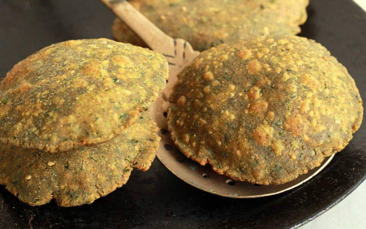 What Are the Most Popular Rajasthan Famous Food Dishes? 12 Methi Bajra Puri traditional Rajasthani fried bread made with millet flour and fenugreek leaves