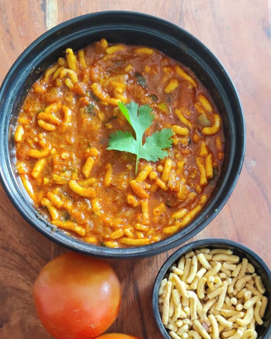 What Are the Most Popular Rajasthan Famous Food Dishes? 17 Rajasthani Sev Tamatar tangy tomato curry topped with crispy sev and spices