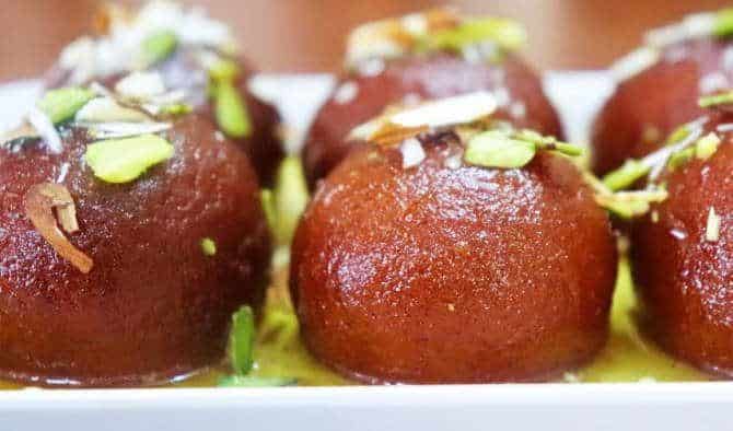 Which Famous Food of Madhya Pradesh Can You Not Miss? 5 Rich Mawa Bati sweet garnished with dry fruits and saffron syrup