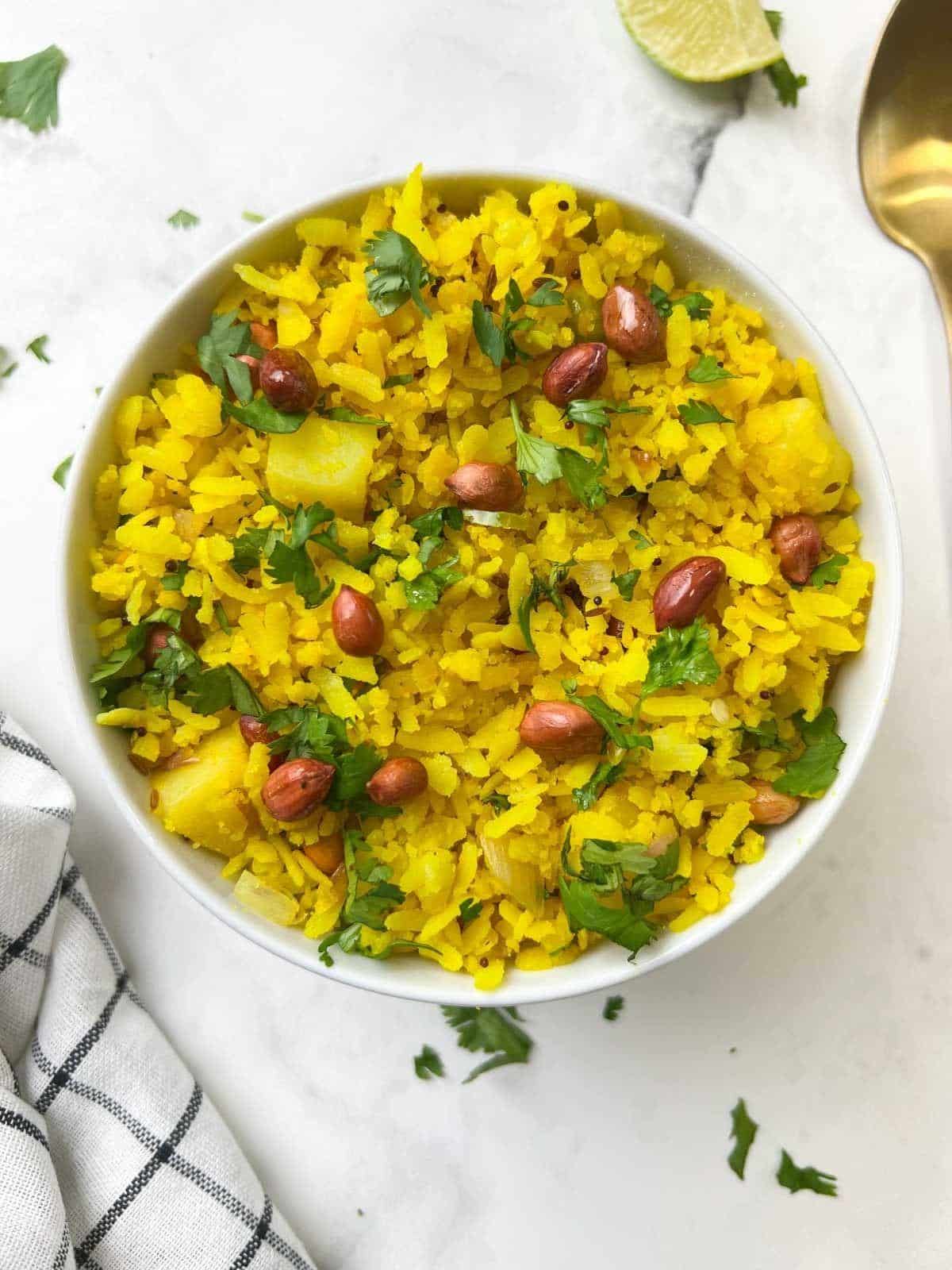Which Famous Food of Madhya Pradesh Can You Not Miss? 1 Traditional Indori Poha topped with sev coriander onions and pomegranate seeds