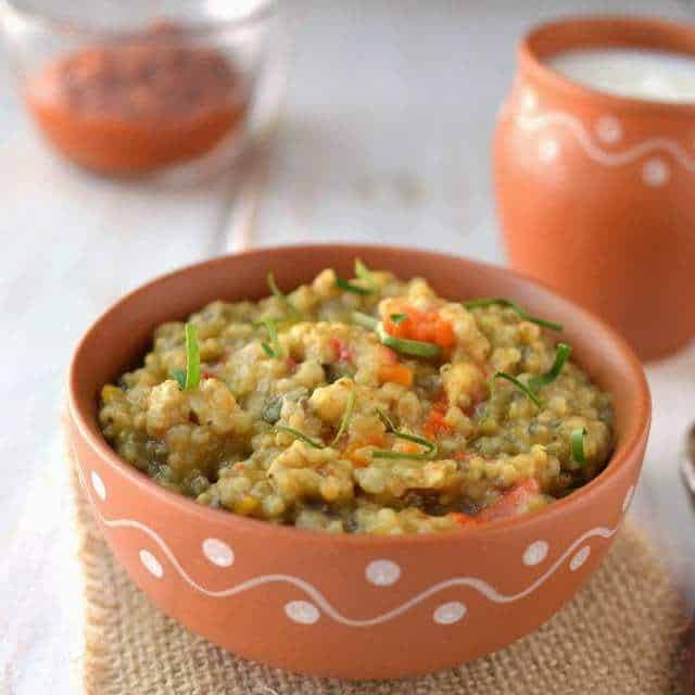 What Are the Famous Food of Haryana You Must Try? 1 Bajra Khichdi served in a bowl with ghee and coriander traditional Haryana dish
