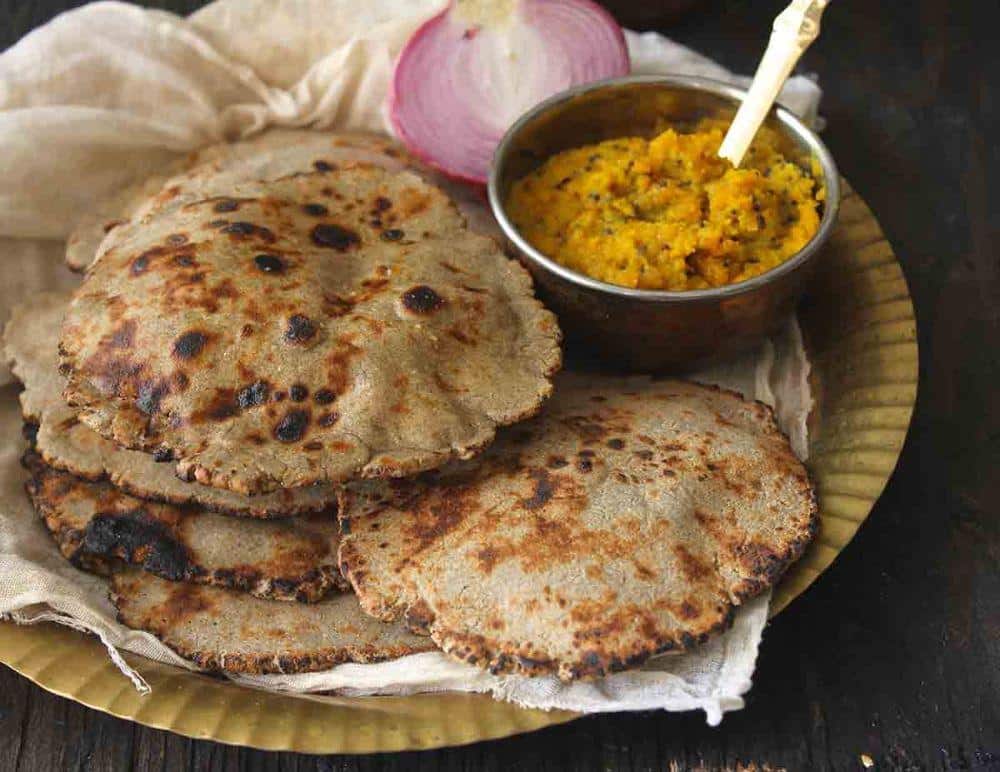 What Are the Famous Food of Haryana You Must Try? 17 Bajre ki roti made with pearl millet flour served with butter on a plate