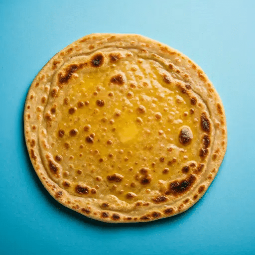 What Are the Famous Food of Haryana You Must Try? 14 Bhura roti with ghee topped with sugar served on a plate