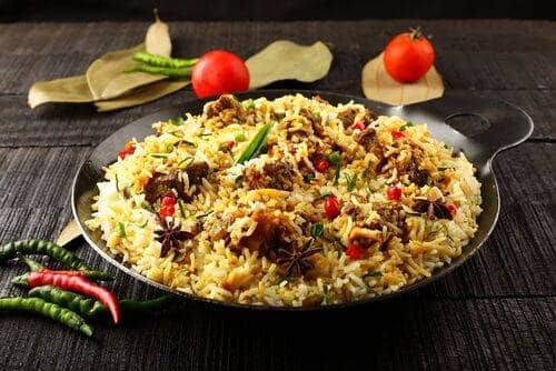 What Are the Most Famous Foods of Uttar Pradesh? 1 Awadhi biryani served in a traditional bowl with fragrant rice spiced meat and garnish