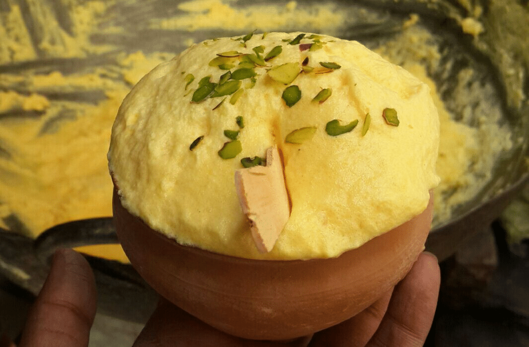 What Are the Most Famous Foods of Uttar Pradesh? 10 Malaiyyo a frothy winter dessert from Varanasi topped with pistachios and served in a clay bowl
