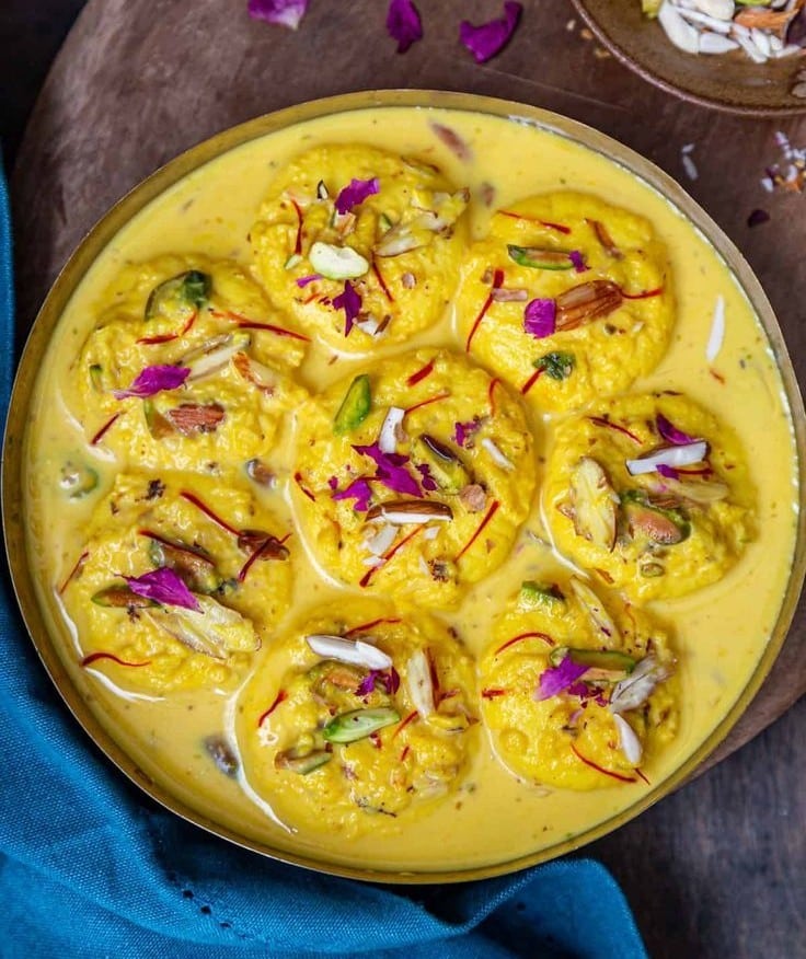 What Are the Most Famous Foods of Uttar Pradesh? 6 Rasmalai with soft paneer discs soaked in sweet saffron milk garnished with nuts