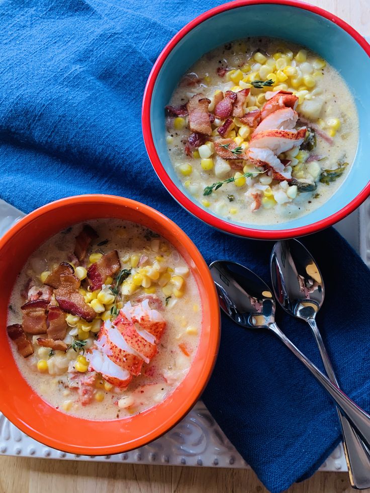 Two bowls of Lobster Corn Chowder with two spoons