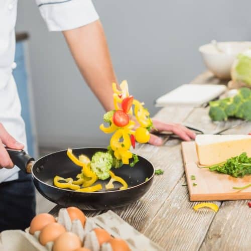 Chef cooking veggies without oil