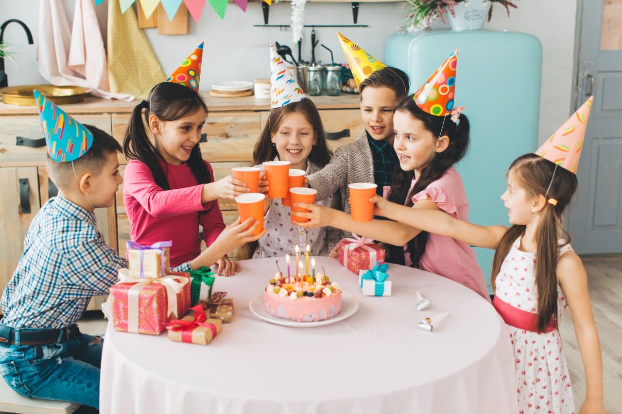 children enjoyimg in a birthday party with fun foods and drinks