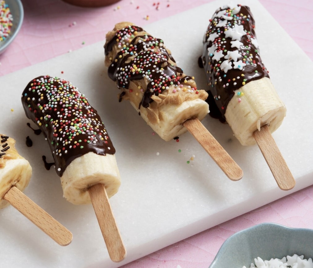 chocolate dipped bananas on a plate 