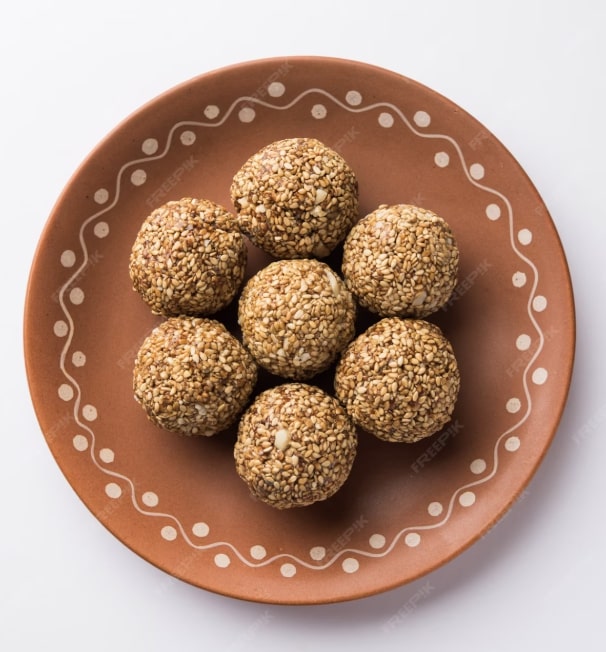 jaggery and sesame laddus in a bowl 