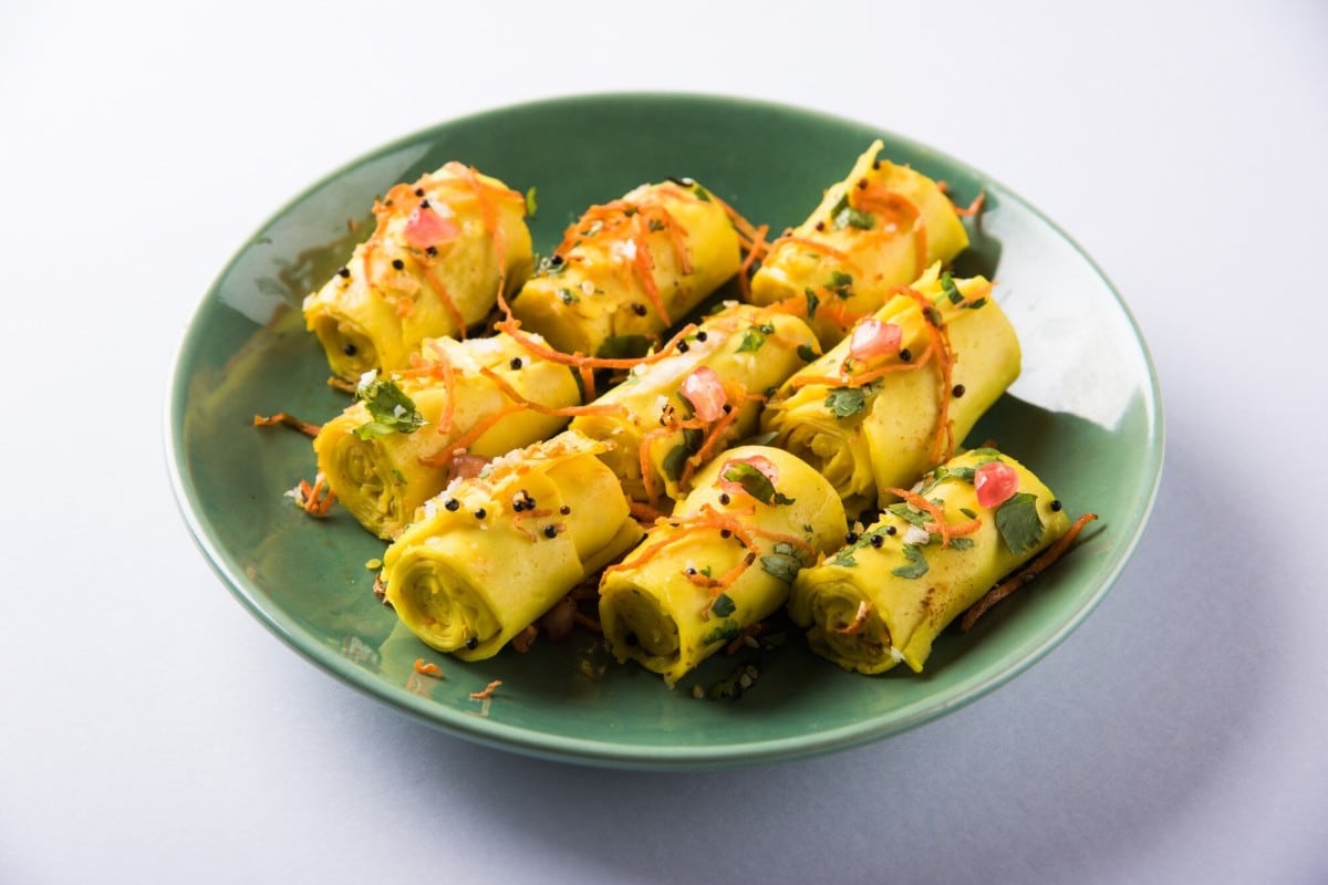 What are the 10 Best Ideas for Cooking Without Fridge? 9 A plate of Khandvi rolls garnished with grated carrots pomegranate and fresh coriander