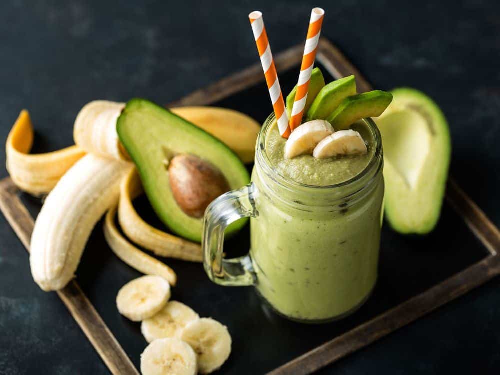 What Are the Benefits of Smoothies and Juices for Health? 8 Avocado banana smoothie served with fresh avocado and banana slices
