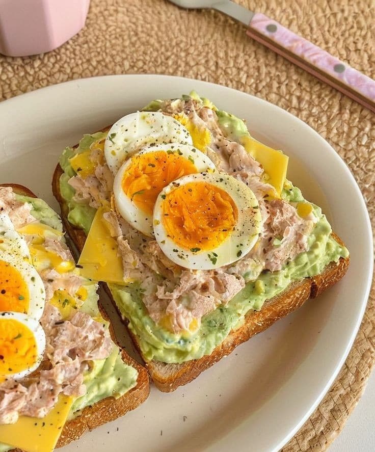 What Are Dietary Fats and Which Types Are Healthy? 13 Avocado toast topped with eggs and chilli flakes on wholegrain bread