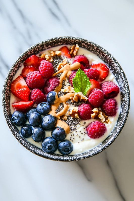 What Are Dietary Fats and Which Types Are Healthy? 15 Greek yoghurt breakfast bowl topped with walnuts almonds berries and chia seeds