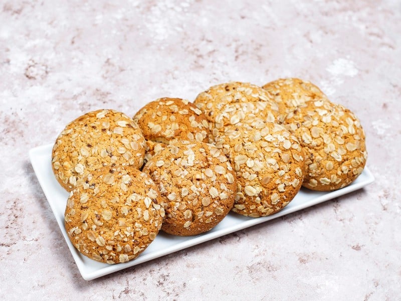 Which 10 Instant Hangover Cure Tips Should You Try Today? 9 Oatmeal cookies placed on a white plate against a light background