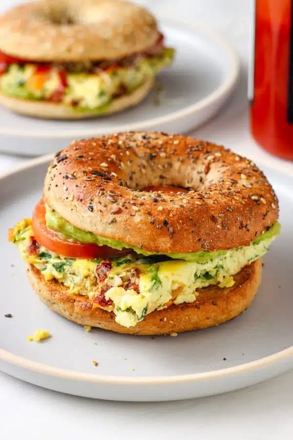 What Are the 25 Best Brunch Dishes for Weekend Meals? 48 Breakfast bagel sandwich filled with eggs cheese and vegetables