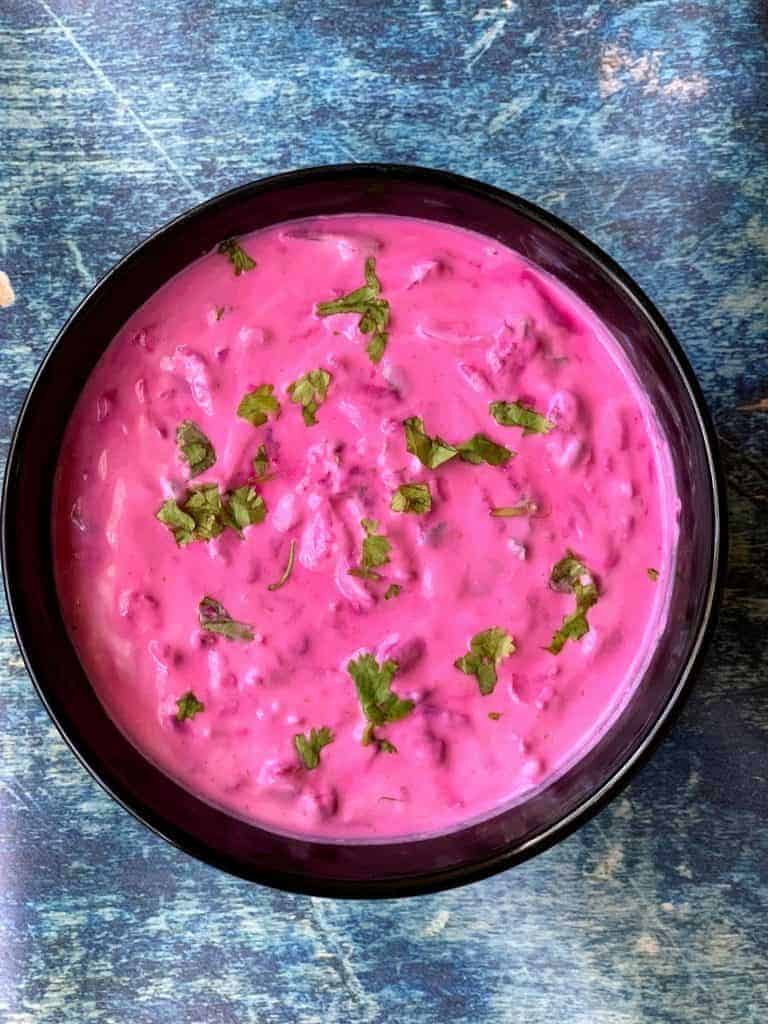 What Are the Health Benefits of Beetroot in Daily Diets? 18 Creamy beetroot raita made with yoghurt grated beetroot and fresh herbs in a serving bowl