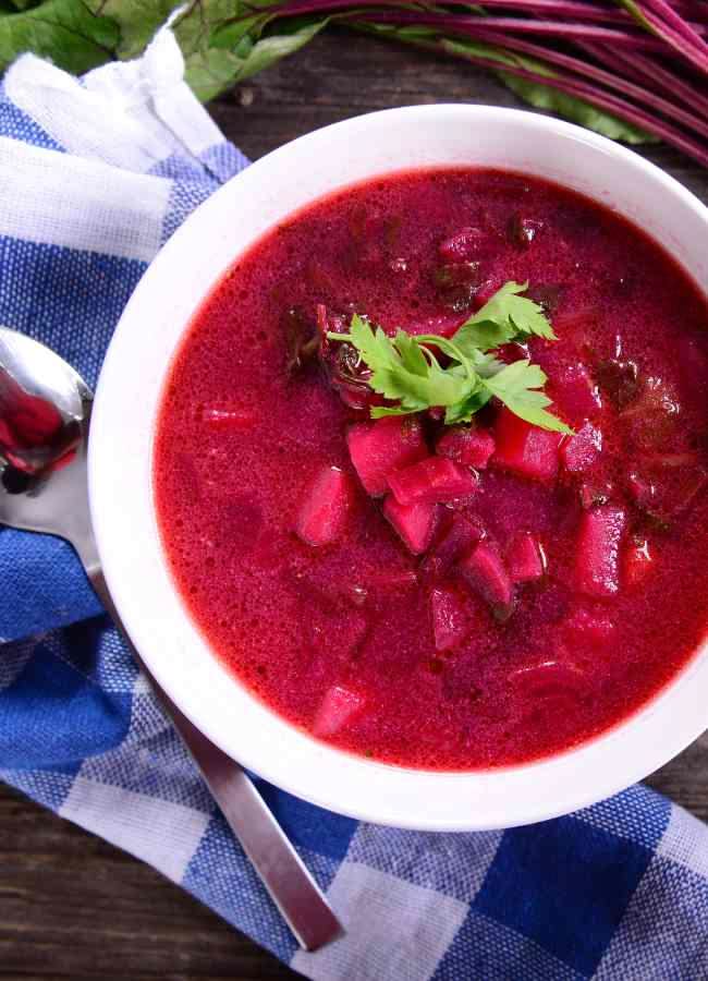 What Are the Health Benefits of Beetroot in Daily Diets? 16 Creamy beetroot soup served warm with herbs and yoghurt in a bowl