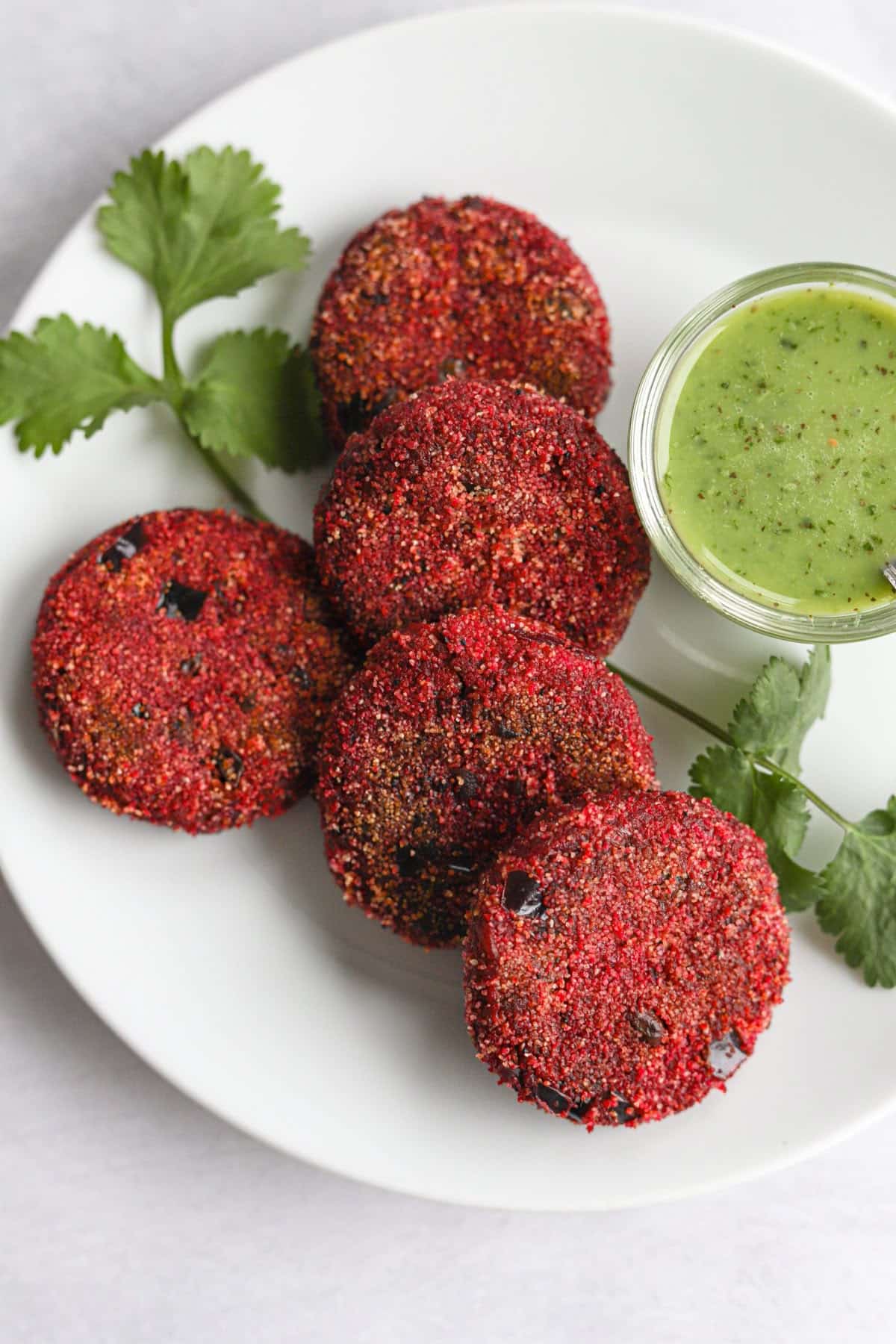 What Are the Health Benefits of Beetroot in Daily Diets? 19 Crispy beetroot cutlets served with mint chutney and fresh herbs on a plate