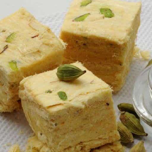 What Are the 25 Best Indian Sweets Everyone Loves? 45 Flaky soan papdi cubes garnished with pistachios