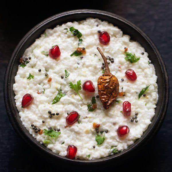What Are the Best Summer Food Items to Stay Cool? 1 Curd rice served in a bowl with pomegranate seeds curry leaves and mustard tempering a cooling summer food item